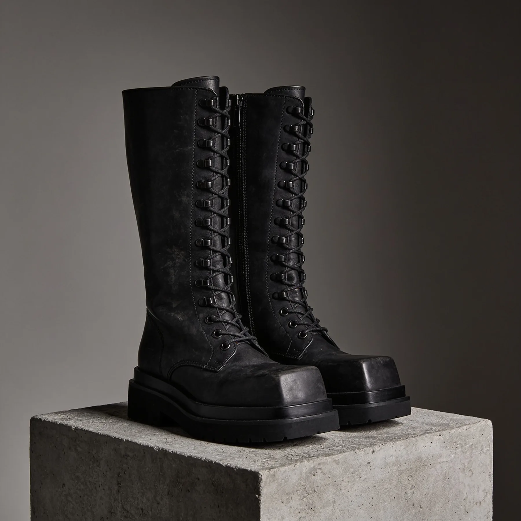 Grave Boot, tall black leather boot on a concrete plinth