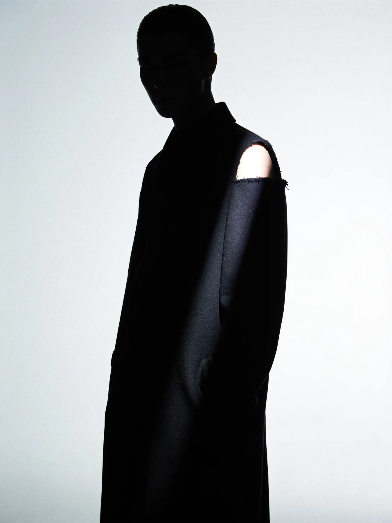 Untitled, a figure in an unidentifiable long black garment almost entirely in shadow